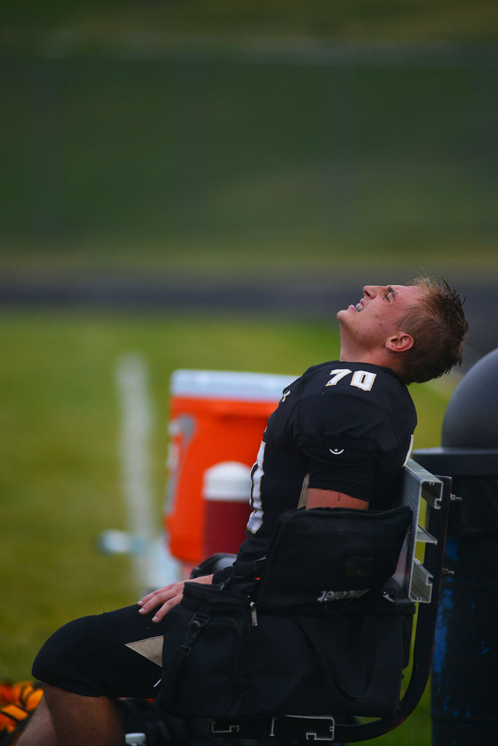 Aidan O’Neill squinches in pain after being helped to the bench